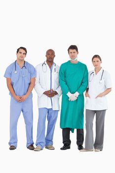Confident medical team standing together against a white background