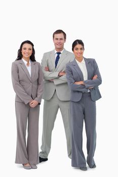 Young businessteam with arms folded against a white background