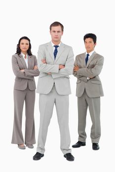 Serious young businessteam standing together against a white background