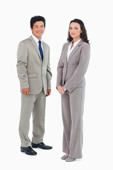 Young office employees standing together against a white background