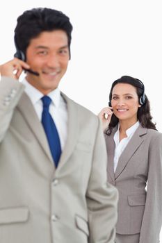 Smiling customer support employees against a white background