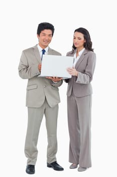 Young salesteam together with laptop against a white background