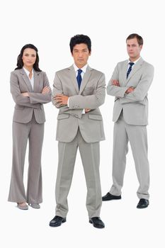 Young businessteam with folded arms against a white background