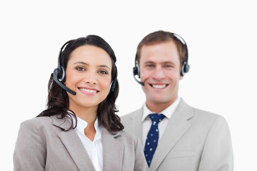 Smiling call center agents standing together against a white background