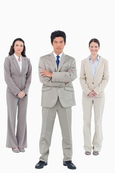 Confident businessman with his team behind him against a white background