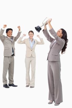 Victorious businesswoman with cup against a white background