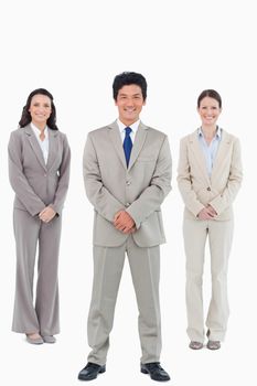 Smiling tradesteam standing together against a white background