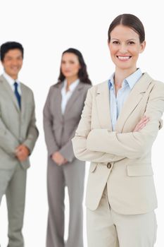 Smiling tradeswoman with employees behind her against a white background