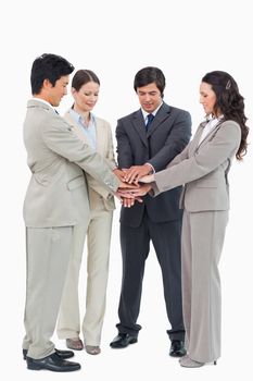 Businessteam performing self motivation ritual against a white background