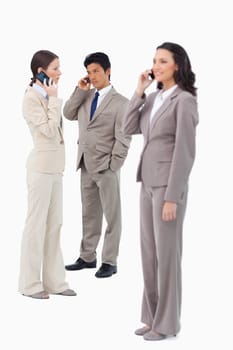 Salespeople on their cellphones against a white background