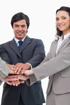 Young businessteam putting hands together against a white background