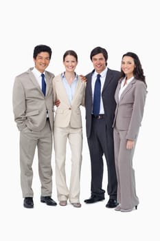 Smiling young salespeople standing together against a white background