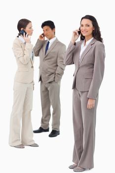 Businesspeople on their phones against a white background