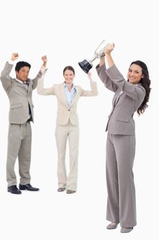 Successful tradeswoman holding cup against a white background