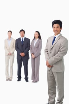 Businessman standing with his associates behind him against a white background