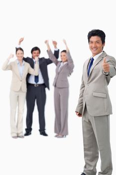Salesman giving thumb up while getting celebrated against a white background
