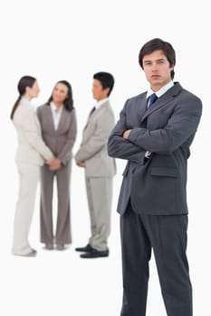 Tradesman with arms folded and associates behind him against a white background