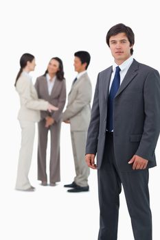 Tradesman with colleagues behind him against a white background