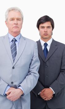 Mature businessman with his colleague against a white background