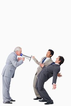 Mature salesman with megaphone yelling at his employees against a white background