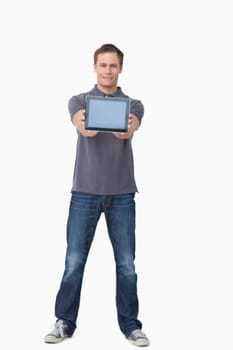 Young man showing screen of his tablet computer against a white background