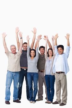 Cheering group of friends raising their arms against a white background