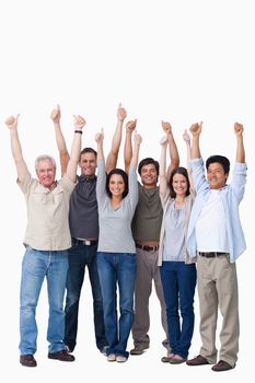 Smiling group of friends giving thumbs up against a white background