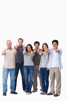 Smiling group giving thumbs up against a white background