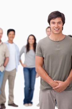 Smiling young male with friends behind him against a white background