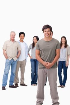 Smiling young man with friends behind him against a white background