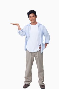 Male presenting with his palm up against a white background