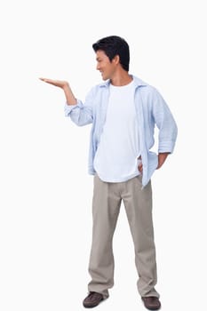 Male looking at his palm against a white background