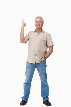 Smiling mature male pointing up against a white background