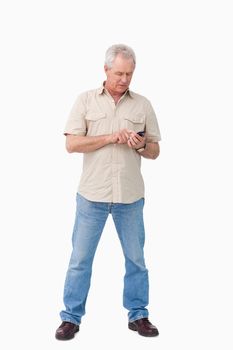 Mature man writing text message against a white background