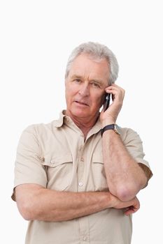 Mature man with his cellphone against a white background