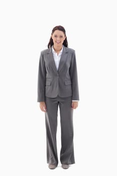 Smiling businesswoman standing against a white background