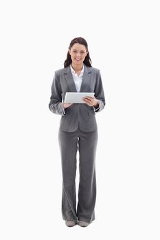 Businesswoman smiling with a touch pad against white background