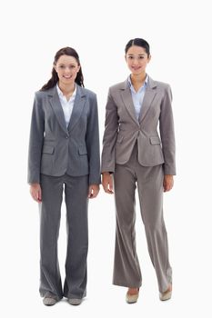 Two businesswomen smiling against white background