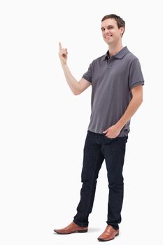 Happy man standing and presenting something above against white background