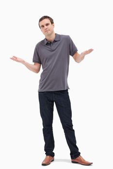 Man shrugging his shoulders against white background