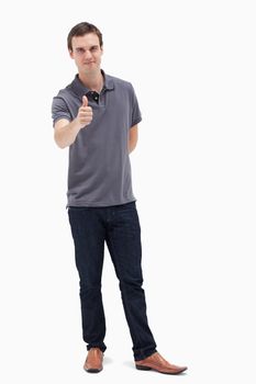 Man approving with his thumb up against white background