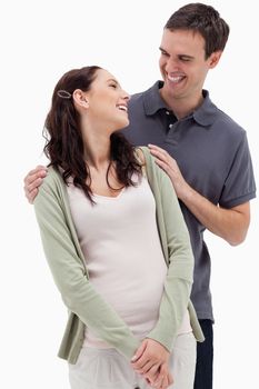 Close-up of a couple who laughs together against white background