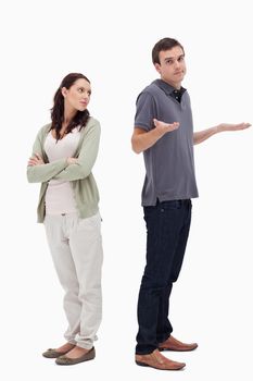 Man shrugged his shoulders back to back with woman against white background