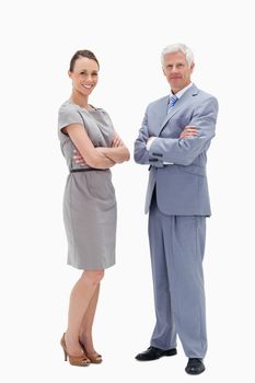 White hair man face to face with a woman crossing their arms and smiling against white background