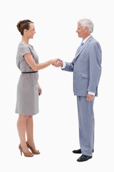 White hair man face to face with a woman and shaking hands against white background