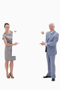 White hair businessman holding and pointing to a big white sign with a woman against white background