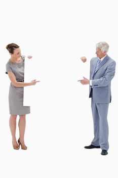 Woman holding and pointing to a big white sign with a white hair businessman against white background