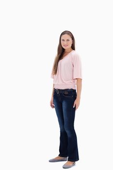 Woman smiling slightly in profile against white background