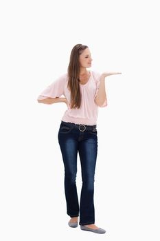 Young woman presenting against white background
