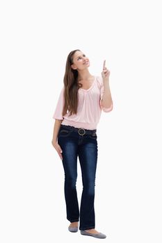 Young woman presenting something above with her hand against white background